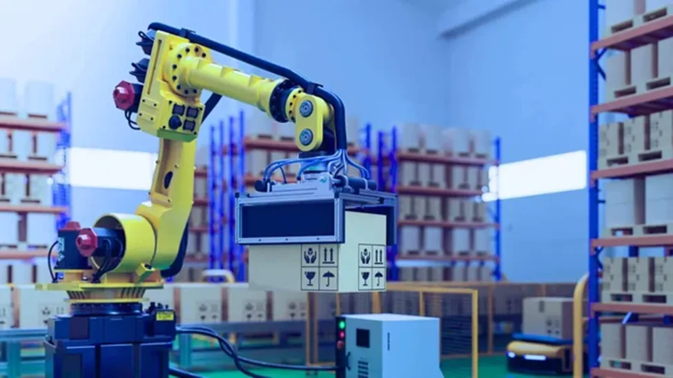 A yellow industrial robotic arm lifting a cardboard box in a high-tech warehouse with blue shelving.