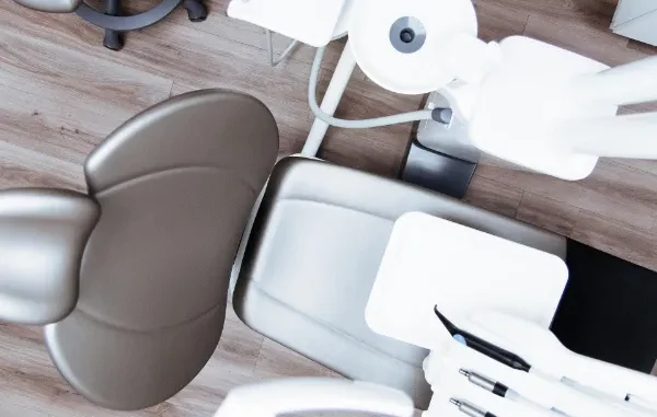 High-angle view of a modern, clean aesthetic clinic treatment chair and medical equipment in a luxury US clinic.