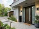 A newly installed modern dark wood impact front door with integrated frosted glass panels, a smart lock, and sturdy black framing on a contemporary stone and stucco home facade.
