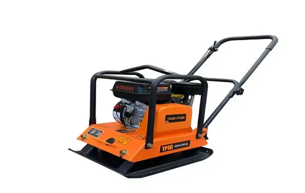 An orange and black TMG Industrial vibratory plate compactor with a Loncin engine, designed for soil and gravel ground preparation in industrial construction.