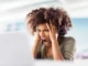 A frustrated female professional holding her head and shouting in front of a laptop, representing the stress of medical billing and lien litigation.