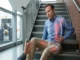 A photo illustration showing a man sitting on stairs, dazed and holding his side after a fall, with an X-ray overlay revealing glowing red internal damage on his ribcage and thigh, contrasting with his seemingly uninjured exterior.