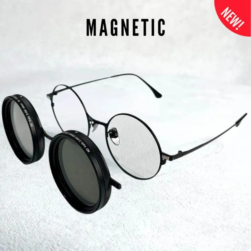 A pair of round, black-rimmed prescription glasses with a magnetic clip-on sunglass lens attachment detaching from the frame.