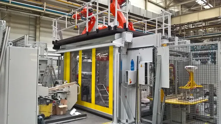 High-speed machine protection door providing safety enclosure for automated robotic equipment in a manufacturing facility.