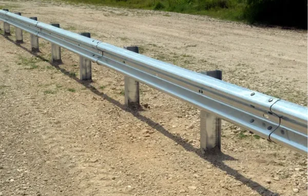 Galvanized steel W-beam highway guardrail installed along a dirt shoulder to prevent vehicle run-off-road accidents.