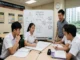 Singapore secondary school students and a tutor collaborating around a whiteboard displaying math problem-solving steps in a tuition classroom.