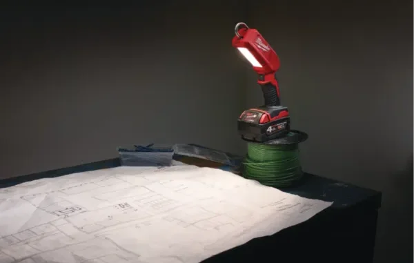 A side-by-side product view of the SurfPrep LED inspection light bar in red casing, shown both turned off to display the bulb array and illuminated to demonstrate its bright raking light beam pattern.