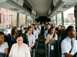 A diverse group of passengers smiling and socializing inside a spacious, modern charter bus driving past Brooklyn brownstones.