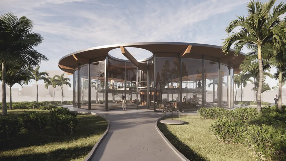 Modern circular glass building with open interior layout surrounded by palm trees, showcasing innovative architectural design.