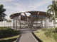 A modern circular glass pavilion designed by an architect, featuring floor-to-ceiling windows and tropical palm tree landscaping.