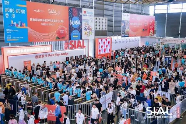 Crowds of attendees entering the exhibition hall at the SIAL global food and beverage trade show under large event banners.