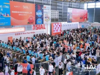 Crowds of attendees gathering at the entrance gates and registration area of the SIAL global food and beverage exhibition.