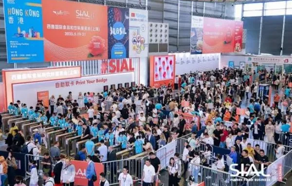 Crowds of attendees gathering at the entrance gates and registration area of the SIAL global food and beverage exhibition.