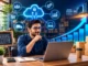 A smiling male small business owner working on a laptop at a desk surrounded by digital icons representing cloud computing, cybersecurity, logistics, e-commerce, and an upward growth trend chart.