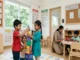 A colorful preschool classroom in Hyderabad featuring Indian children playing with blocks and painting at a table.