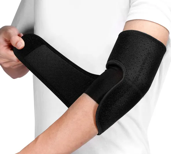 A close-up view of a person applying a medical-style black adjustable compression wrap to their elbow joint, showing the tension strap being secured by their opposite hand against a plain white background.