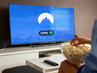 A person holding a bowl of popcorn watching a Smart TV that displays the NordVPN app screen with a green "You are connected" status indicator.