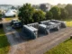 High-angle view of organized portable restrooms and handwashing stations lined up in a designated event zone with a service truck nearby.