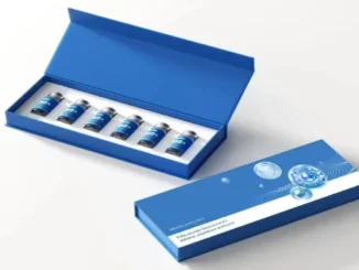A professional-grade, custom blue magnetic-closure rigid box set for peptide vials, showing six small glass vials neatly arranged in a precision-cut white foam insert, with the matching branded outer box displaying technical graphics of molecular structures and text.