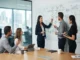 A corporate team standing around a large whiteboard filled with an overly complex, chaotic flowchart during a strategy session.
