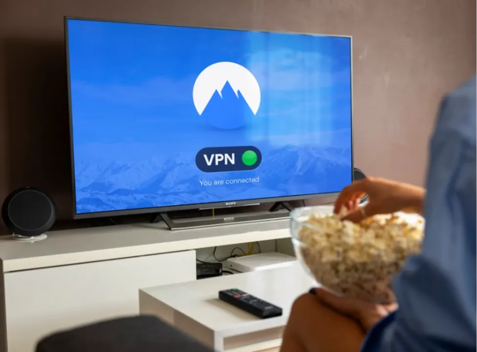 A user streaming content on a Smart TV while connected to NordVPN's shared IP address network for enhanced privacy.