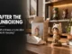 A freshly unboxed collectible figure wearing an animal hood sitting next to its artwork box, crumpled packaging paper, and displayed figurines on a wooden shelf in a sunlit room. On the left, overlay text reads "AFTER THE UNBOXING: What Makes a Collectible Worth Keeping?"