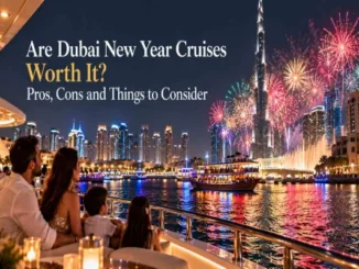 A family sitting on a boat deck watching fireworks light up the sky around the Burj Khalifa and the illuminated Dubai skyline at night.