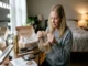 A woman sitting at her vanity table, carefully examining the clips and base of a new blonde hair topper fresh out of its shipping box.