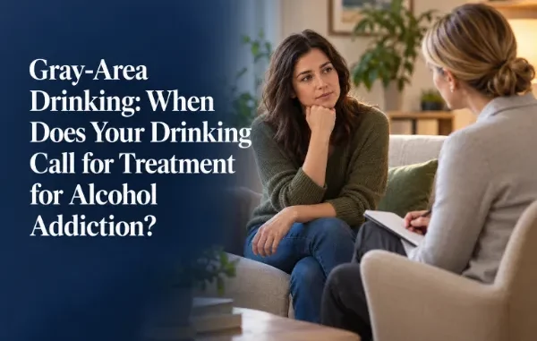 A woman sitting thoughtfully on a couch during a therapy session with a counselor to discuss gray-area drinking and alcohol treatment options.
