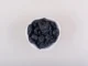 A white bowl filled with dark, resinous Shilajit pieces set against a neutral background, highlighting its traditional use in wellness practices.