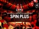 A carnival and circus-themed banner for Spin Plus featuring playing cards, poker chips, a balloon dog, and text reading "Game Zone: Spin Plus - Where Pinoys play card games online."