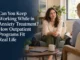 A smiling woman sitting comfortably in an armchair during an outpatient therapy session, speaking with a therapist taking notes in a bright, cozy office setting.